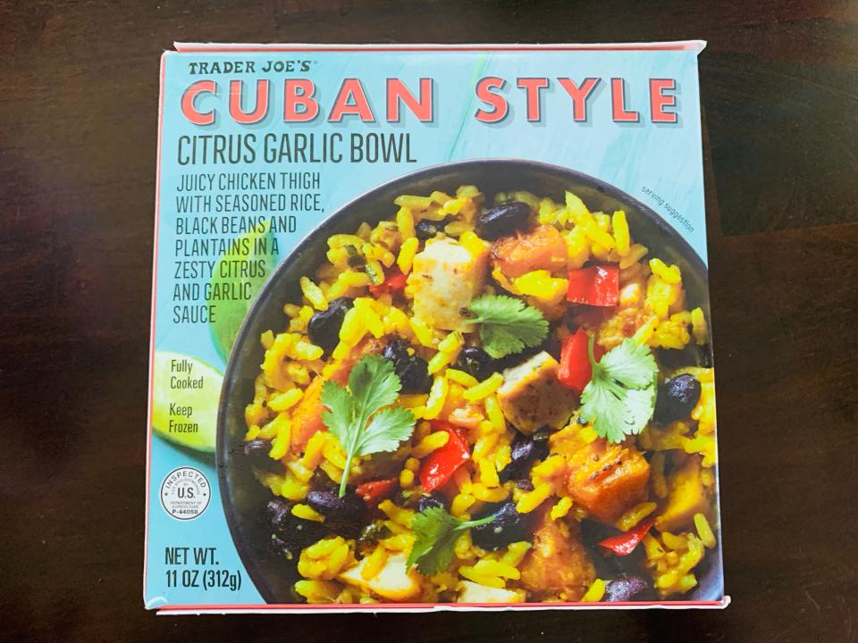 Trader joe's cuban-style rice bowl in blue packaging on wooden table