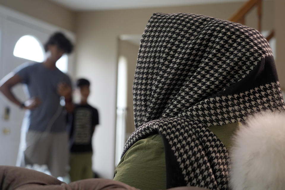 An Afghan refugee, who agreed to be photographed on the condition that she not be identified for security concerns, sits during an interview with an Associated Press journalist in Bensalem, Pa., Thursday, Aug. 26, 2021. (AP Photo/Michael Perez)