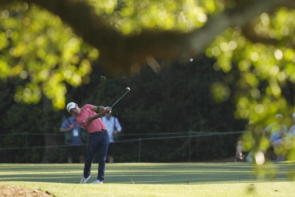 Collin Morikawa hits from the fairway on the 18th hole during third round of the Masters on Saturday.
