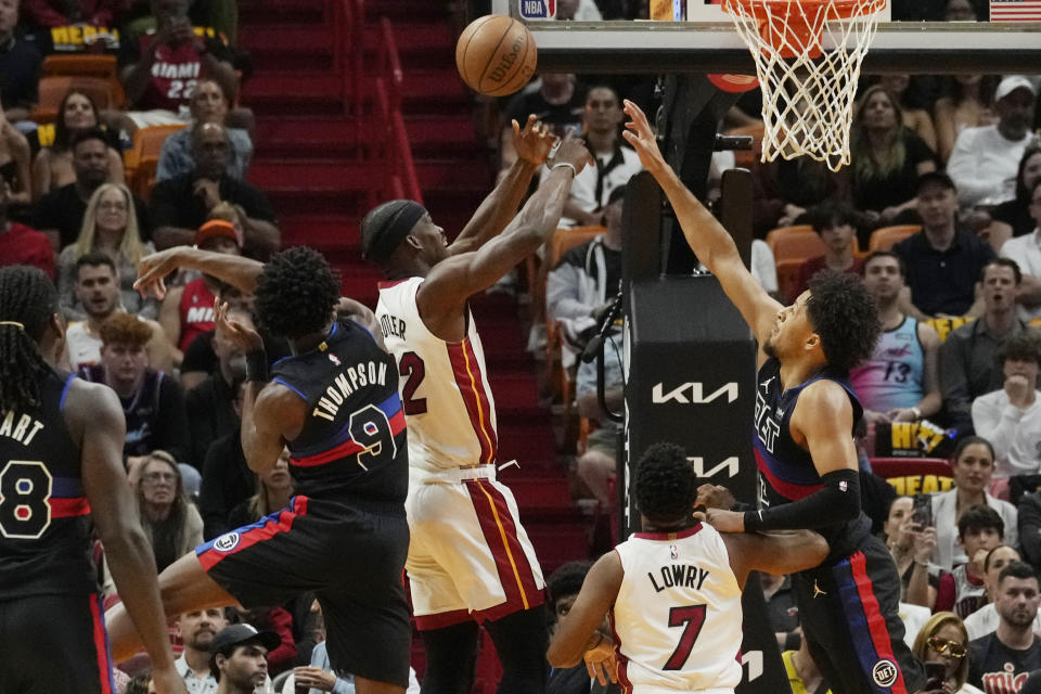 Detroit Pistons forward Ausar Thompson (9) swipes the ball away from Miami Heat forward Jimmy Butler (22) during the first half of an NBA basketball game, Wednesday, Oct. 25, 2023, in Miami. (AP Photo/Marta Lavandier)