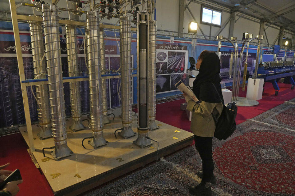 A student looks at Iran's domestically built centrifuges in an exhibition of the country's nuclear achievements, in Tehran, Iran, Feb. 8, 2023.  / Credit: Vahid Salemi/AP