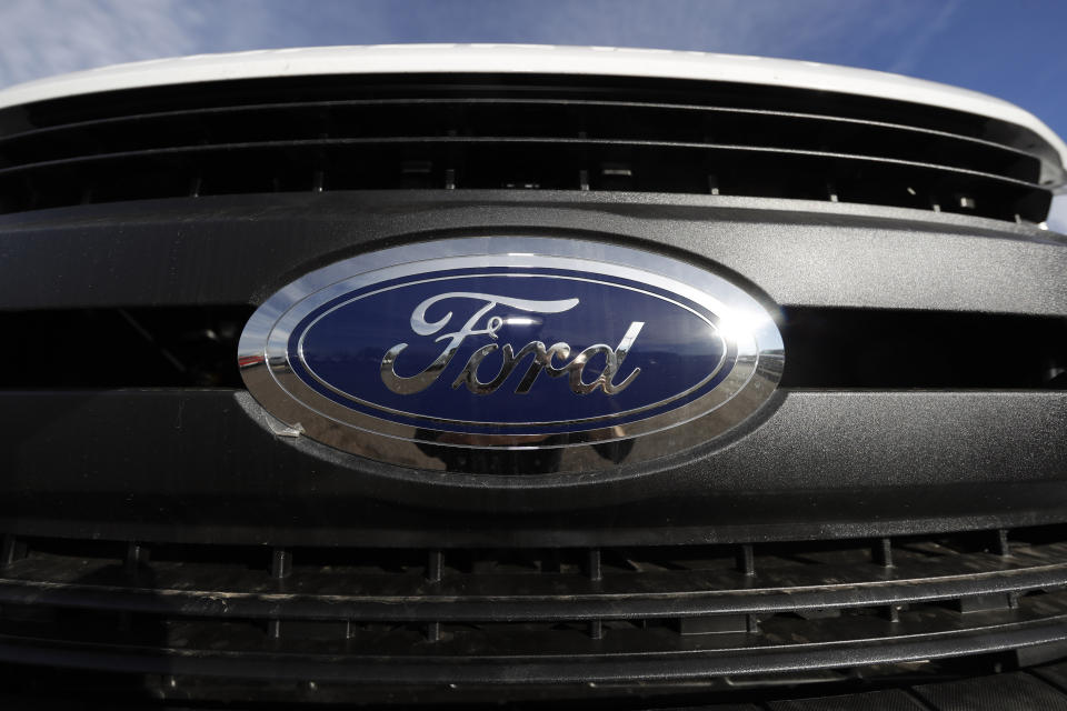 FILE - In this Nov. 10, 2019, file photograph, the company logo shines off the grille of an unsold F-350 pickup truck at a Ford dealership in Littleton, Colo. Ford Motor Co. is recalling nearly 262,000 heavy-duty pickup trucks in the U.S. and Canada because the tailgates can open unexpectedly. The recall covers F-250, F-350 and F-450 trucks from the 2017 through 2019 model years. All the trucks have electric tailgate latch release switches in the tailgate handle. (AP Photo/David Zalubowski, File)