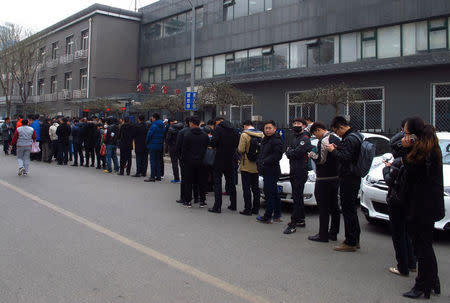 People line up outside a real estate registration office center in Chaoyang district in Beijing, China, March 20, 2017. Picture taken March 20, 2017. REUTERS/Muyu Xu