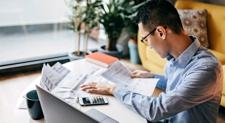 Man looking at his bank account to see if the IRS took money out.