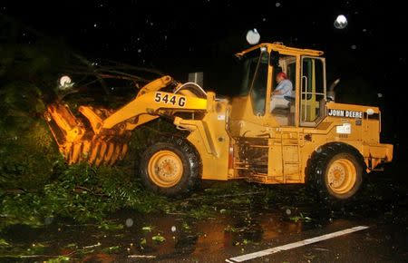 Maintenance crews remove debris blocking a road in the rain and wind from Hurricane Hermine Tallahassee, Florida, U.S. September 2, 2016. REUTERS/Phil Sears