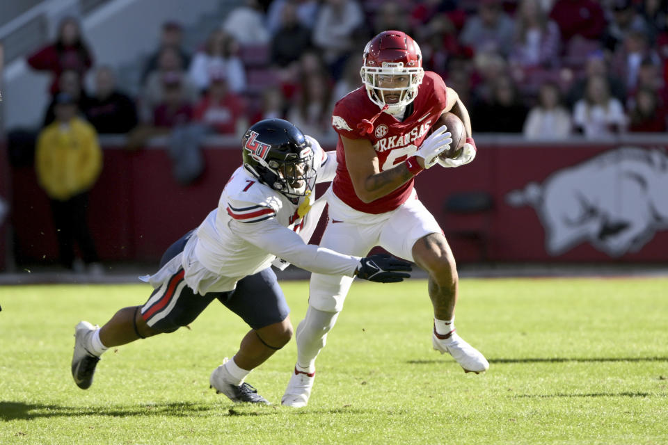 Arkansas wide receiver Jadon Haselwood, right, is tackled by Liberty linebacker Mike Smith Jr. (7) during the first half of an NCAA college football game Saturday, Nov. 5, 2022, in Fayetteville, Ark. (AP Photo/Michael Woods)