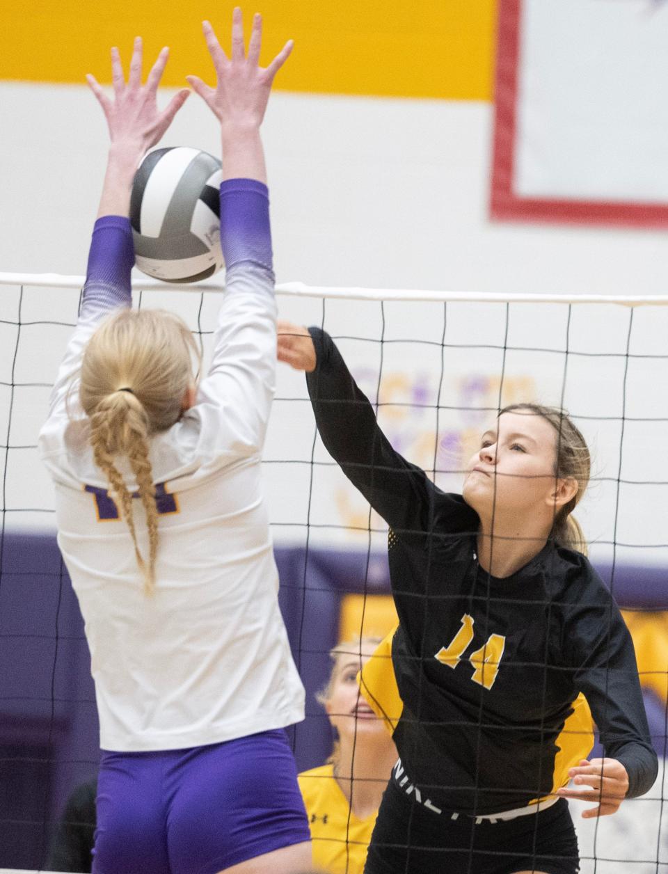 Jackson's Taylor Wake blocks a shot from Perry's Bailey Weirich during Tuesday's match.