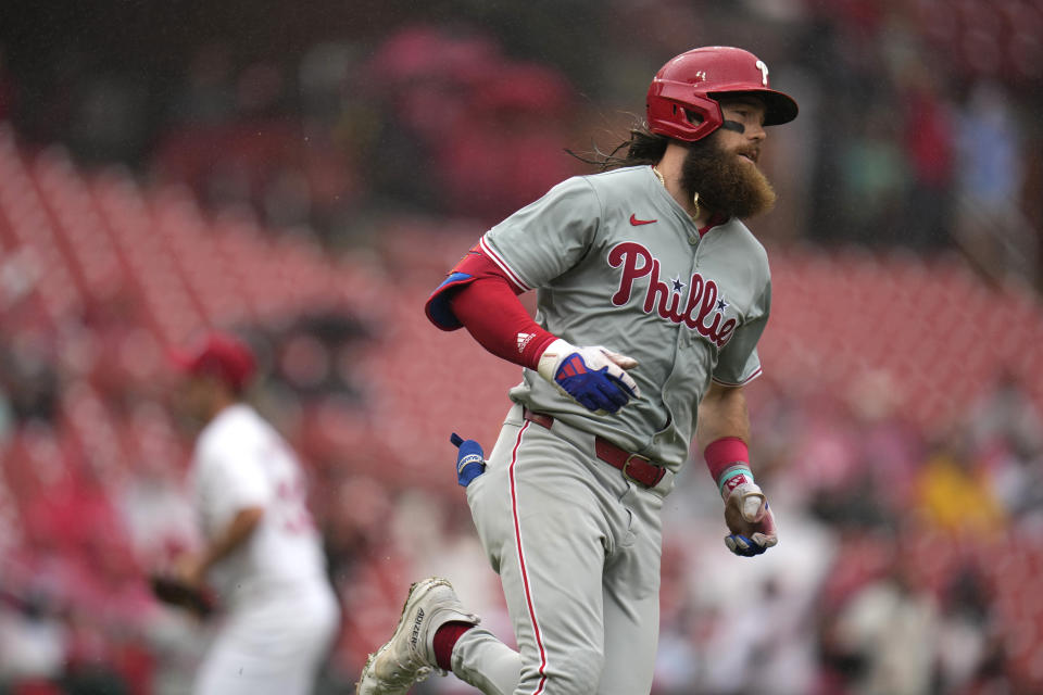 Philadelphia Phillies' Brandon Marsh heads to first after hitting an RBI single off St. Louis Cardinals relief pitcher Andre Pallante, left, during the sixth inning of a baseball game Wednesday, April 10, 2024, in St. Louis. (AP Photo/Jeff Roberson)