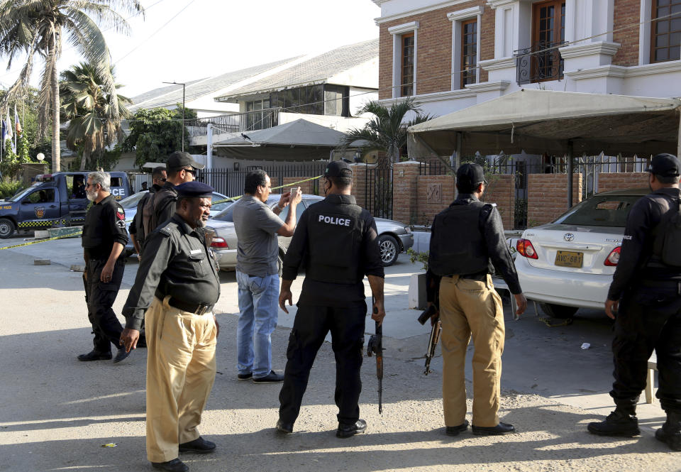 Police officers visit the Chinese Consulate to investigate Friday's attack on the Chinese Consulate in Karachi, Pakistan, Saturday, Nov. 24, 2018. Pakistani police say the suicide bomber that struck the country's Chinese consulate used foreign-made C-4 plastic explosive and suggested the attack was orchestrated in India. (AP Photo/Shakil Adil)