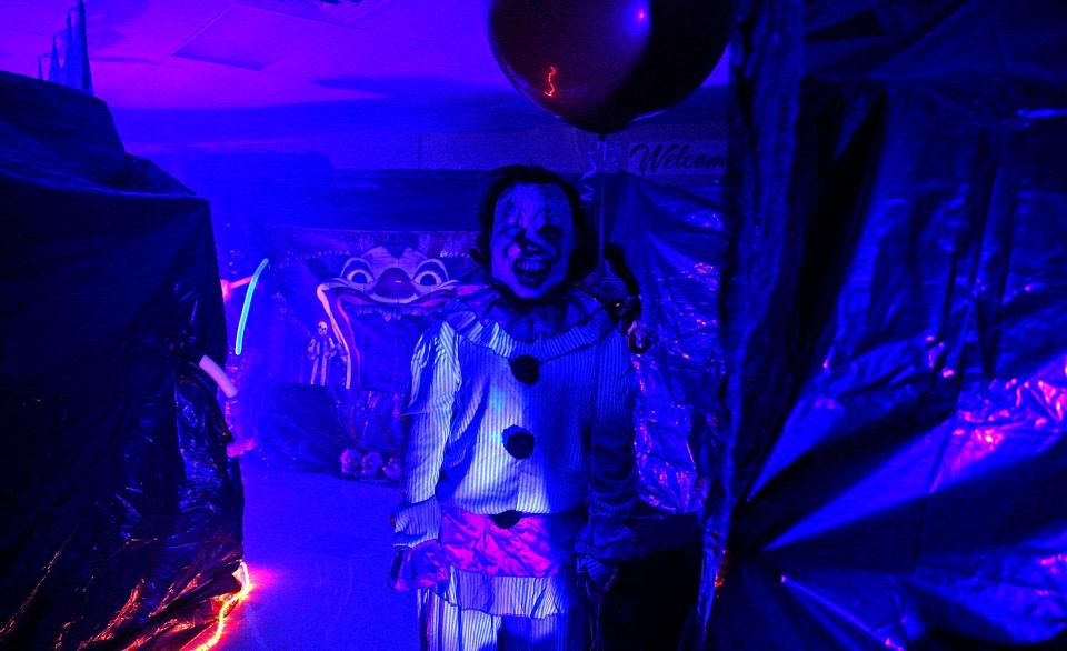 A costumed individual waits for the next group of people to make their way through the haunted house at the Boo Bash Halloween event at Bowie Elementary School on Thursday, Oct. 28, 2021.