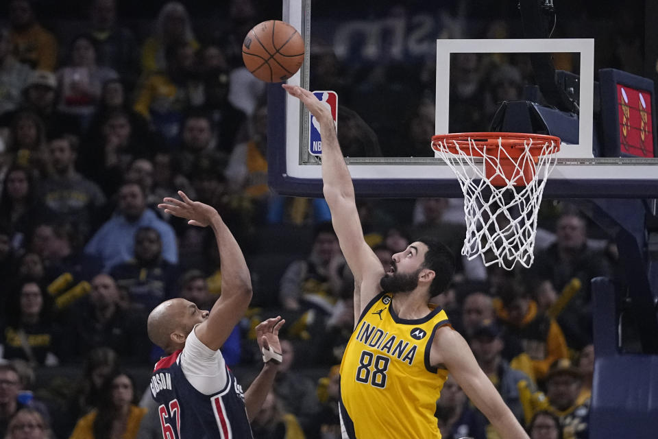 Indiana Pacers center Goga Bitadze (88) blocks a shot by Washington Wizards forward Taj Gibson (67) during the first half of an NBA basketball game, Friday, Dec. 9, 2022, in Indianapolis. (AP Photo/Darron Cummings)