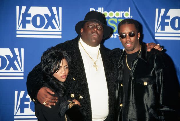 East Coast rapper Chris Wallace, known as The Notorious B.I.G., stands between songwriter Sean 