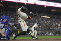 San Francisco Giants' Heliot Ramos hits an RBI single against the Los Angeles Dodgers during the sixth inning of a baseball game Monday, May 13, 2024, in San Francisco. (AP Photo/Godofredo A. Vásquez)