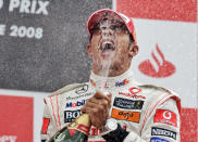 FILE - In this Sunday July 6, 2008 file photo, McLaren Mercedes driver Lewis Hamilton of Britain who won the British Formula One Grand Prix celebrates following the race in Silverstone, England. British driver Lewis Hamilton made Formula One history on Sunday, Oct. 25, 2020 winning the Portuguese Grand Prix for a 92nd win to move one ahead of German great Michael Schumacher. (AP Photo/Lefteris Pitarakis, file)