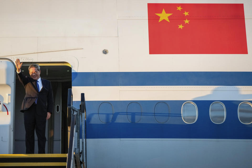 Chinese Premier Li Qiang waves on his arrival at Adelaide Airport, Australia, Saturday, June 15, 2024. Li is on a relations-mending mission with panda diplomacy, rock lobsters and China's global dominance in the critical minerals sector high on the agenda during his four day visit to Australia. (Asanka Brendon Ratnayake/Pool Photo via AP)