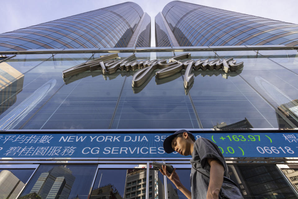 FILE - A pedestrian passes by the Hong Kong Stock Exchange electronic screen in Hong Kong on July 21, 2023. Stocks mostly slipped in mixed trading Monday, Oct. 2, as the constrictor of higher interest rates tightened its coils around Wall Street. (AP Photo/Louise Delmotte, File)