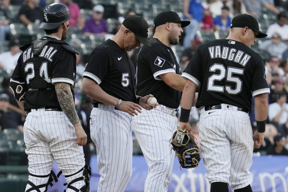 Chicago White Sox catcher Yasmani Grandal, manager Pedro Grifol, third baseman Jake Burger and first baseman Andrew Vaughn, from left, wait for relief pitcher Bryan Shaw during the 11th inning in the first baseball game of the team's doubleheader against the Toronto Blue Jays on Thursday, July 6, 2023, in Chicago. The Blue Jays won 6-2. (AP Photo/Nam Y. Huh)