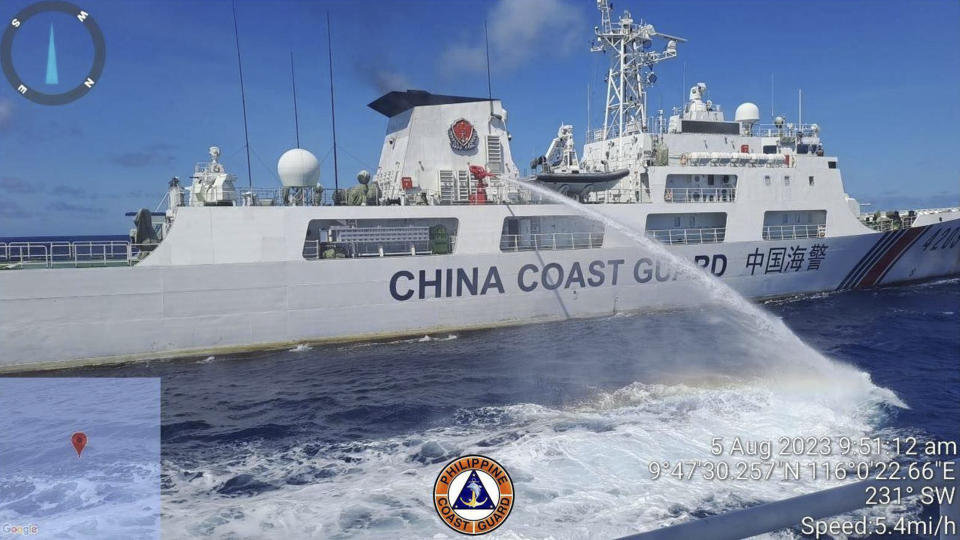 In this handout photo provided by the Philippine Coast Guard, a Chinese coast guard ship uses water canons on a Philippine Coast Guard ship near the Philippine-occupied Second Thomas Shoal, South China Sea as they blocked it's path during a re-supply mission on Saturday Aug. 5, 2023. The Philippine military condemned on Sunday a Chinese coast guard ship's "excessive and offensive" use of a water cannon to block a Filipino supply boat from delivering new troops, food, water and fuel to a Philippine-occupied shoal in the disputed South China Sea. (Philippine Coast Guard via AP)