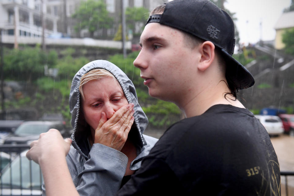 <p>Kelli Myers, who owns two businesses that were flooded, and her son Sam, were rescued from another store further up the street, May 27, 2018, in Ellicott City, Md. This comes two years after another flash flood devastated the historic downtown. (Photo: Katherine Frey/The Washington Post via Getty Images) </p>