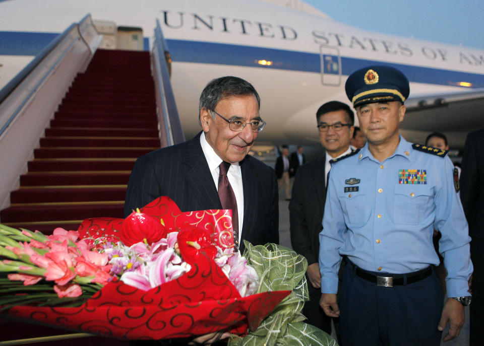 U.S. Secretary of Defense Leon Panetta, left, is welcomed with flowers as China's Chief of the General Staff Gen. Ma Xiao Tian, right, and U.S. Ambassador to China Gary Locke, center, look on after Panetta's arrival at Beijing International Airport Monday, Sept. 17, 2012. Panetta is on his third trip to Asia in 11 months, reflecting the Pentagon's ongoing shift to put more military focus on the Asia-Pacific. (AP Photo/Larry Downing, Pool)