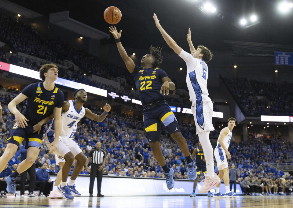 Marquette's Sean Jones (22) shoots against Creighton's Francisco Farabello (5) during the first half of an NCAA college basketball game on Tuesday, Feb. 21, 2023, in Omaha, Neb. (AP Photo/Rebecca S. Gratz)