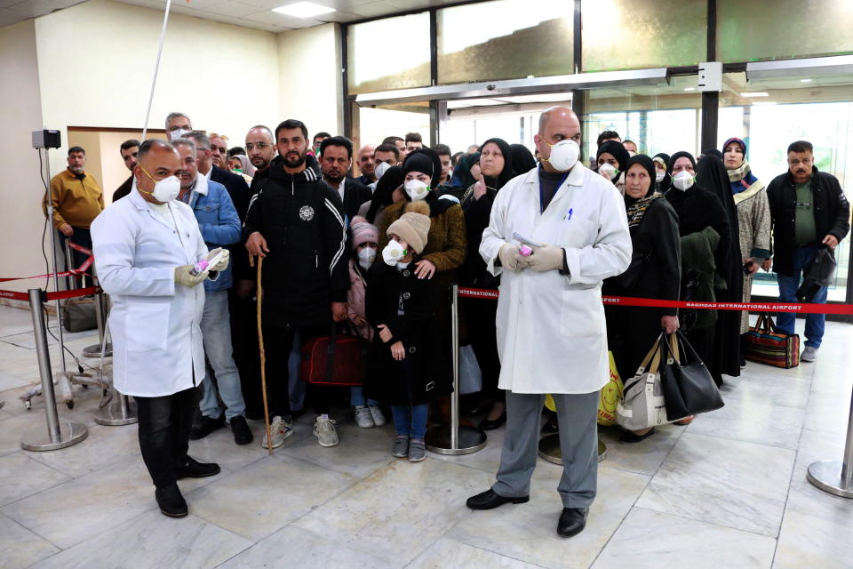 An Iraqi medical team check Iranian passengers as they arrive at Baghdad international airport. Source: AAP