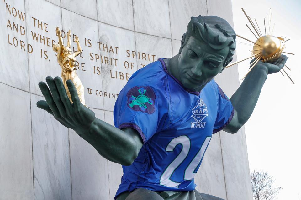 A 2024 NFL draft jersey on the Spirit of Detroit statue in downtown Detroit on Thursday, March 28, 2024.