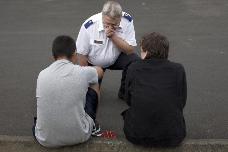 A Salvation Army worker (C) consoles two students after they were evacuated from Marysville-Pilchuck High School in the aftermath of a shooting on the high school's campus on October 24, 2014 in Marysville, Washington