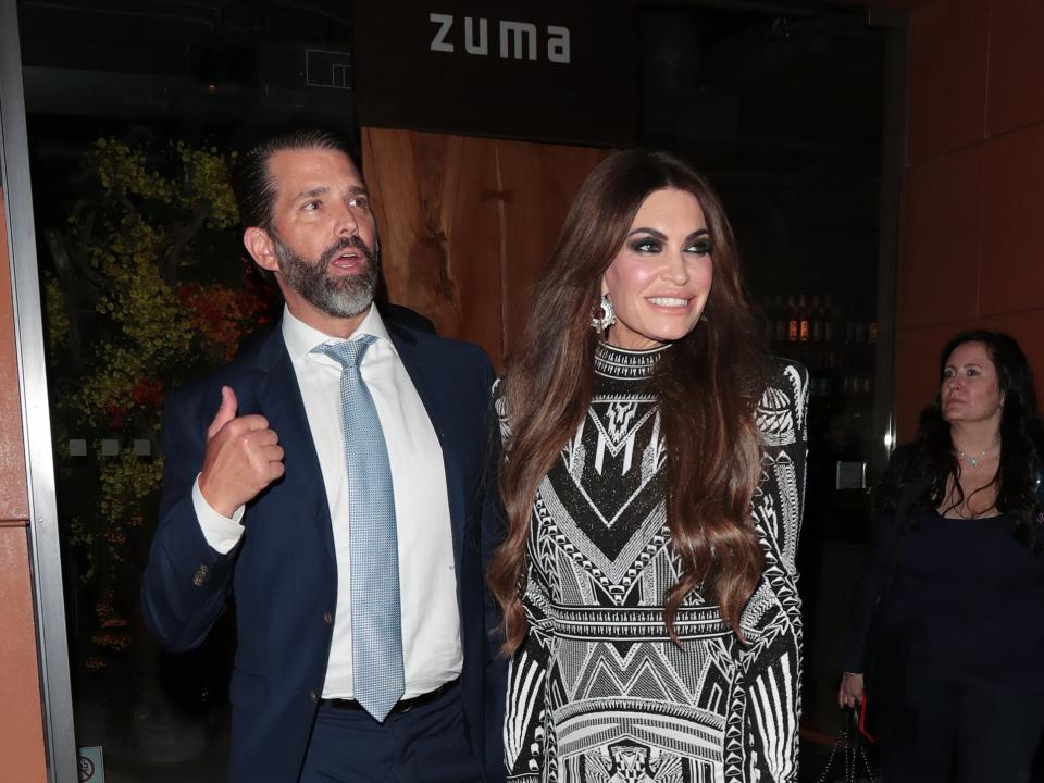 Donald Trump Jr. and Kimberly Guilfoyle leave a restaurant in London.