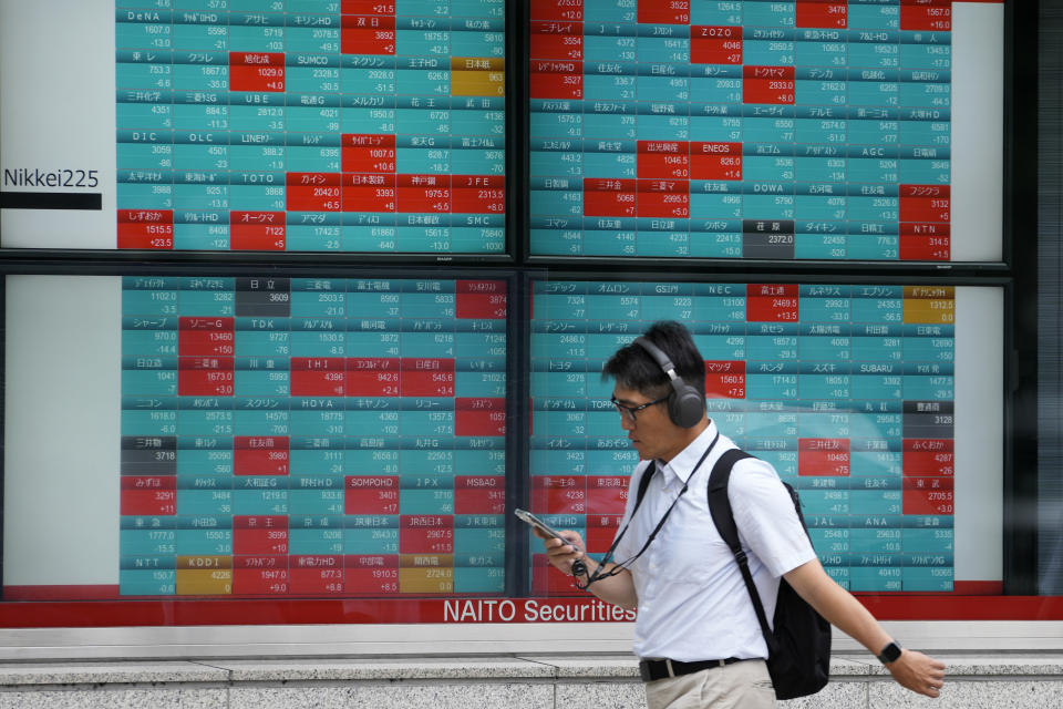 A person walks past at an electronic stock board showing Japan's stock prices at a securities firm Thursday, June 27, 2024 in Tokyo. (AP Photo/Shuji Kajiyama)