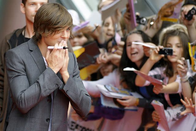 <p>MICHAEL GOTTSCHALK/DDP/AFP via Getty </p> Zac Efron in 2009 premiering '17 Again'