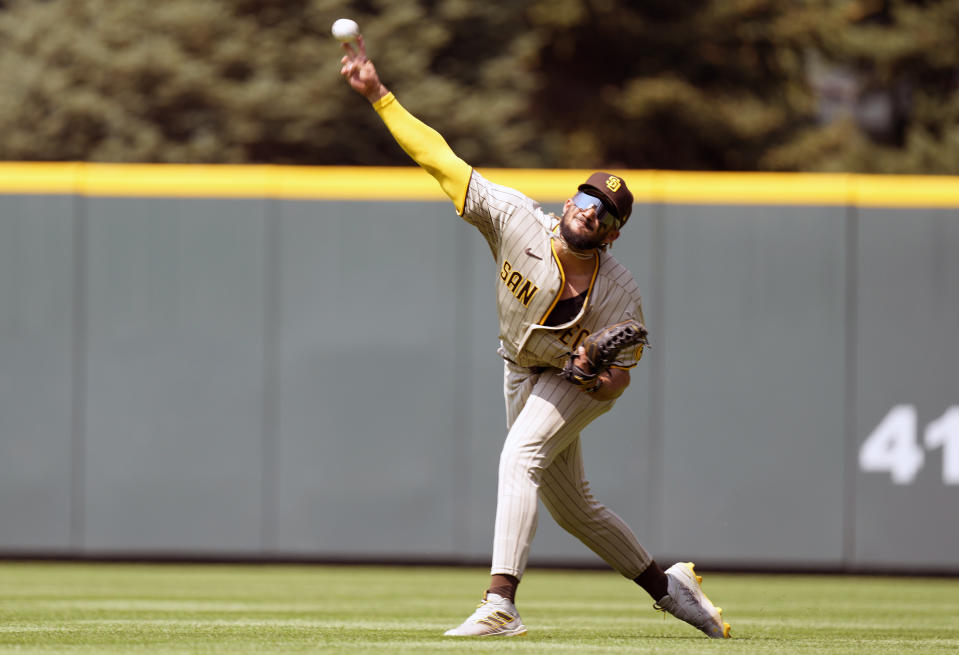 San Diego Padres right fielder Fernando Tatis Jr. throws to home plate after fielding an RBI-single off the bat of Colorado Rockies first baseman C.J. Cron in the third inning of a baseball game Wednesday, Aug. 18, 2021, in Denver. (AP Photo/David Zalubowski)