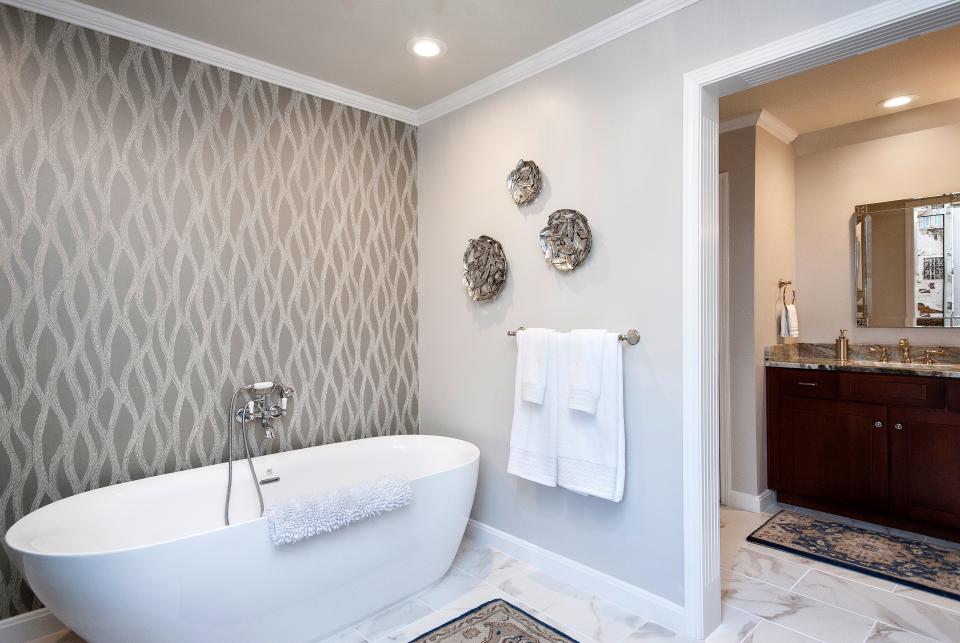 Transitional and timeless: Silver accents throughout the bedroom and adjoining bath add a bit of bling.