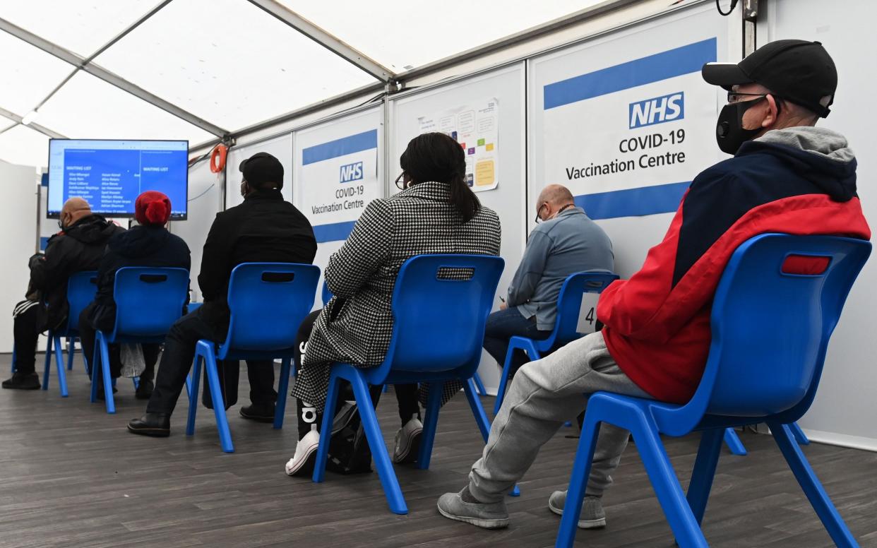 People wait for their Covid-19 booster jabs at a vaccination centre in London - Andy Rain/EPA-EFE/Shutterstock