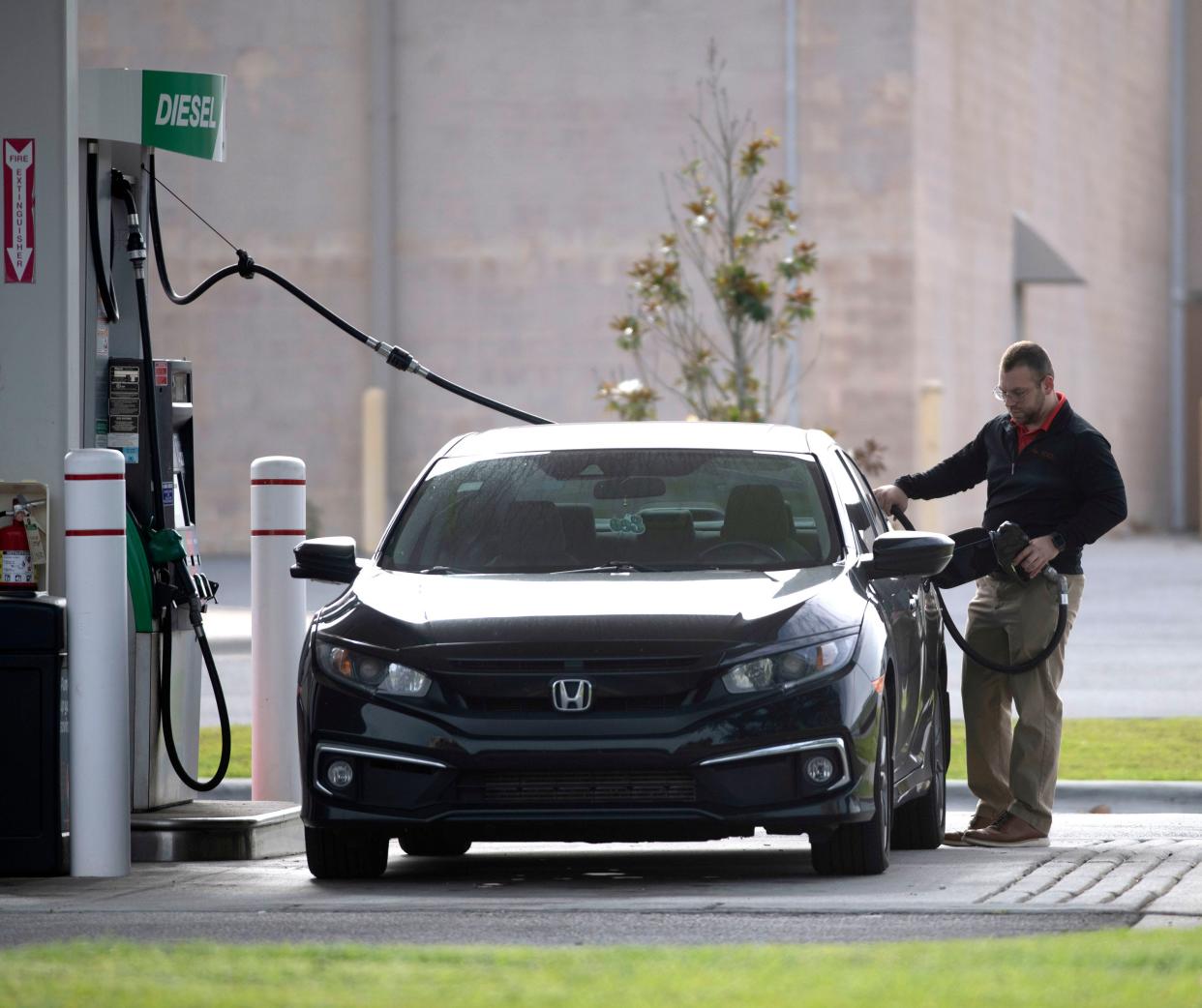 A motorist fills up his tank Thursday at BJ's Wholesale Club on North Davis Highway in Pensacola.