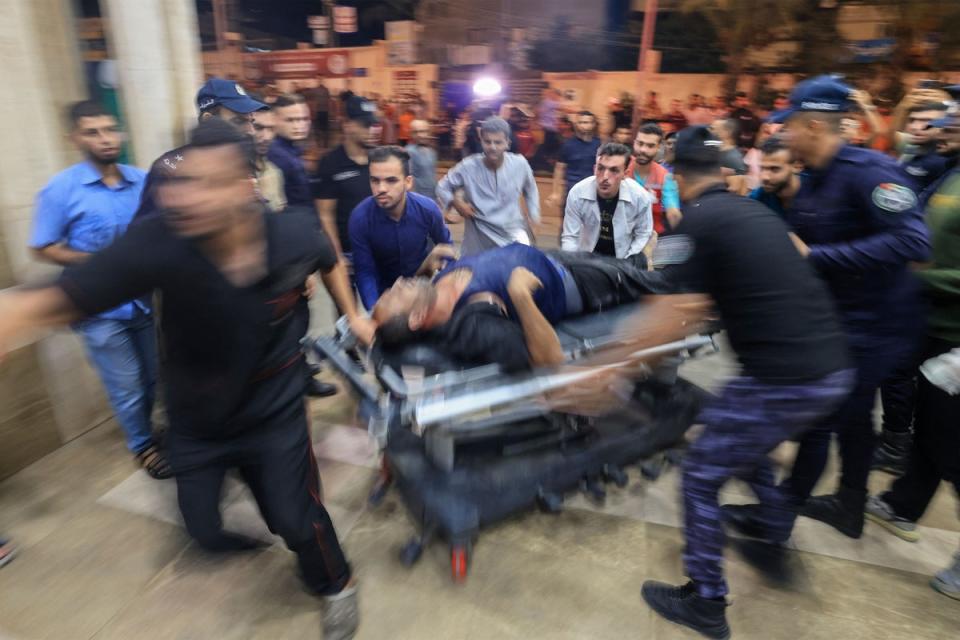 A Palestinian man injured in an Israeli air strike is wheeled inside the Nasser hospital in Khan Yunis (AFP via Getty Images)