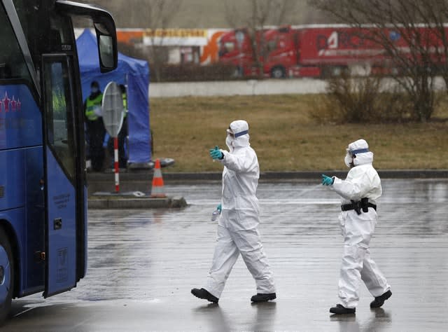 Medical staff enter a German bus at the Czech border