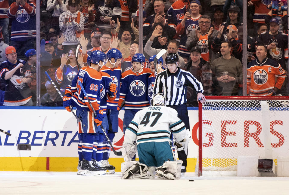 San Jose Sharks goalie James Reimer (47) looks on as the Edmonton Oilers celebrate a goal during first-period NHL hockey game action in Edmonton, Alberta, Monday, March 20, 2023. (Jason Franson/The Canadian Press via AP)