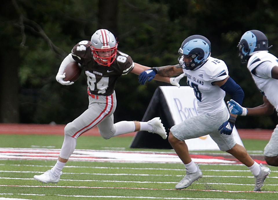 Brown receiver Wes Rockett fends off a URI defender during a game in 2021. Rocket is a key returnee for the Bears this season.