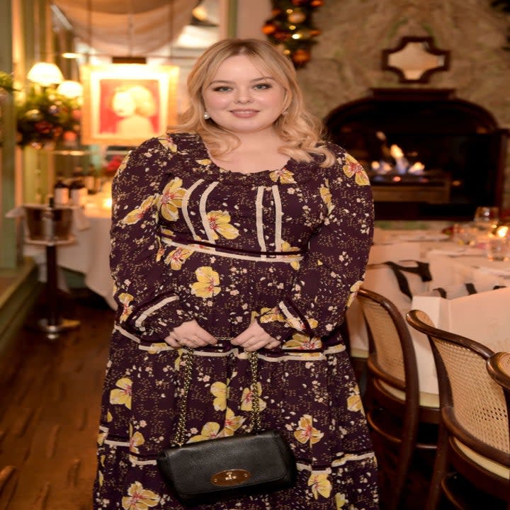 Nicola poses for the camera in a floral dress