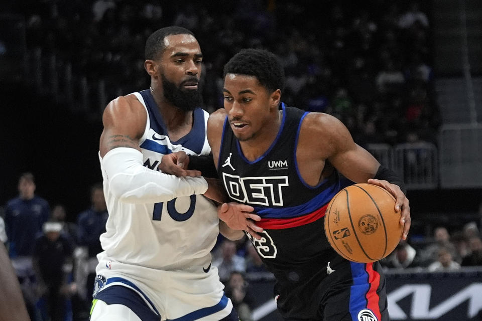 Detroit Pistons guard Jaden Ivey (23) drives on Minnesota Timberwolves guard Mike Conley (10) in the first half of an NBA basketball game in Detroit, Wednesday, Jan. 17, 2024. (AP Photo/Paul Sancya)