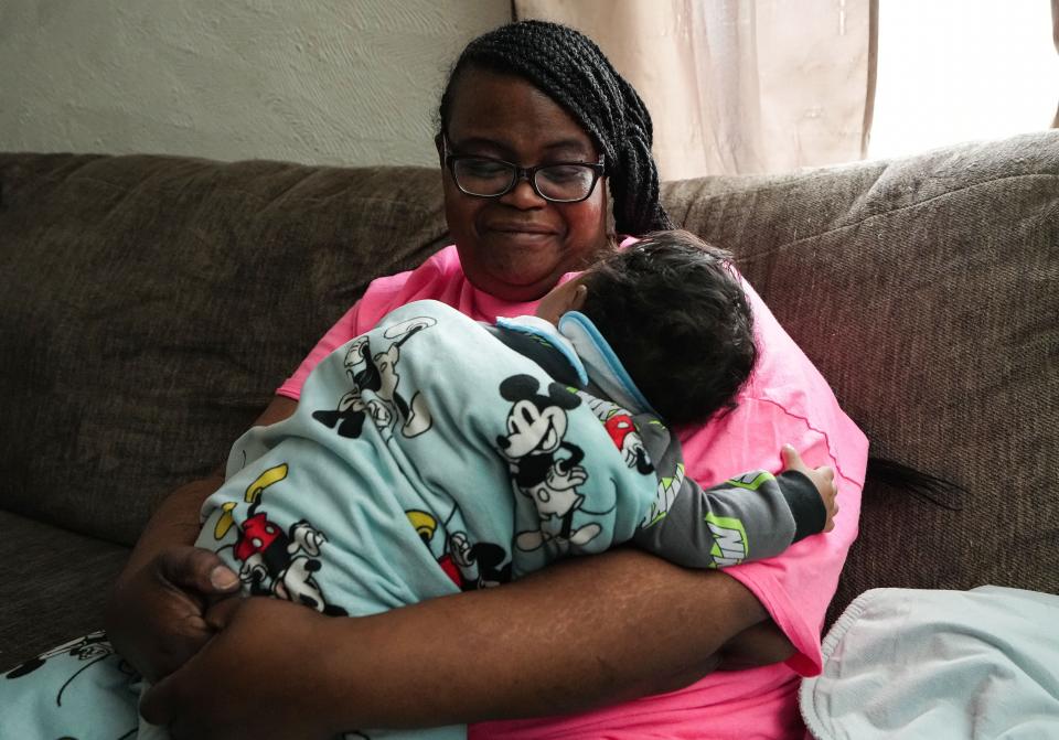 "This is my new muse," Angela Hughley said while holding her grandson Keion Adams. Hughley, 42, was shot in the chest during last April's mass shooting at a FedEx center on the southwest side of Indianapolis. Hughley holds her grandson on Saturday, April 9, 2022, at her home in Indianapolis.