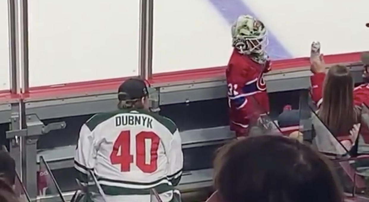 Minnesota Wild goaltender Devan Dubnyk looks on as a young Montreal Canadiens fan tries on his mask at the Bell Centre on Thursday night. (Twitter//@NHL)