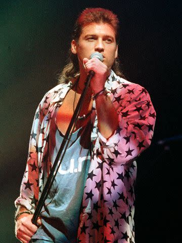 <p>Rick Diamond/Getty </p> Billy Ray Cyrus performs in 1993