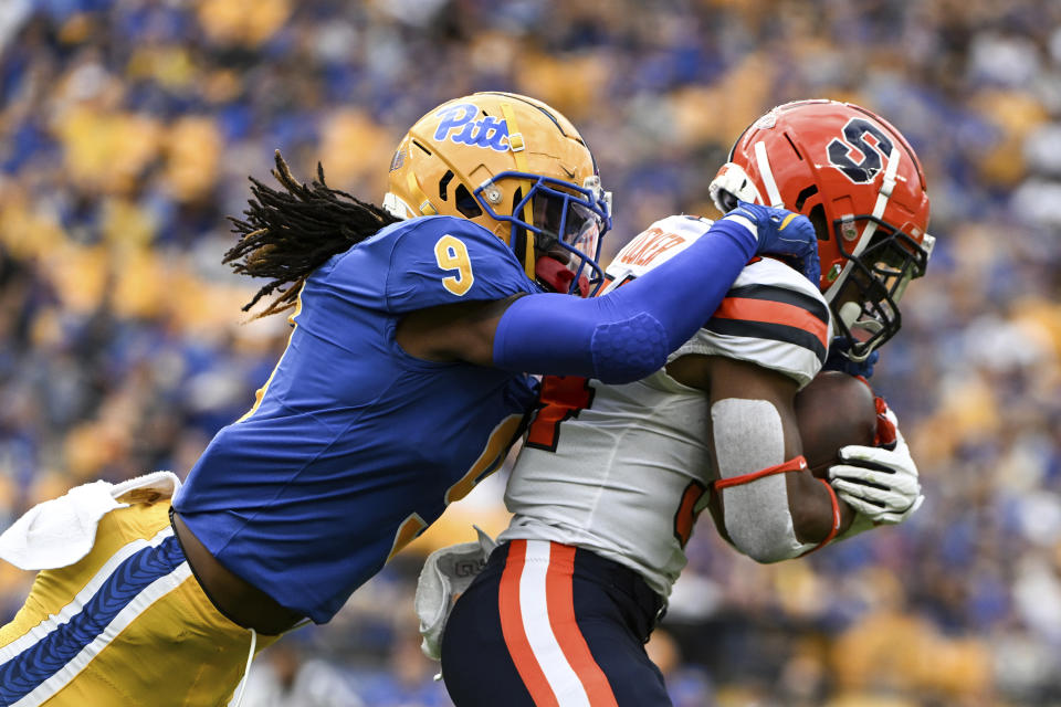 Pittsburgh defensive back Brandon Hill (9) tackles Syracuse running back Sean Tucker (34) during the first half of an NCAA college football game, Saturday, Nov. 5, 2022, in Pittsburgh. (AP Photo/Barry Reeger)