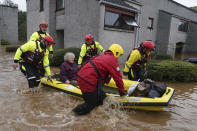 Members of the emergency services evacuate a woman from a flooded area in Brechin, Scotland, Friday Oct. 20, 2023. The gale-force winds are expected to hit hardest the eastern part of Denmark's Jutland peninsula and the Danish islands in the Baltic Sea. But the British Isles, southern Sweden, northern Germany and parts of Norway also on the path of the storm, named Babet by U.K.’s weather forecaster, the Met Office. (Andrew Milligan/PA Wire/PA via AP)