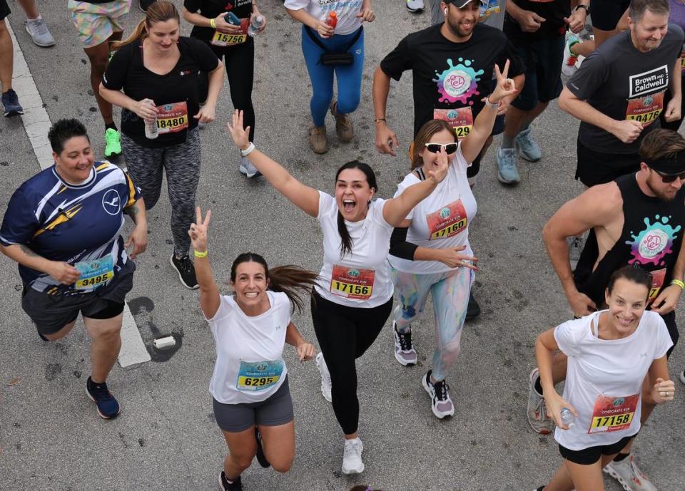 Runners ham it up for the camera at the start of the 3.1 mile race in downtown Miami