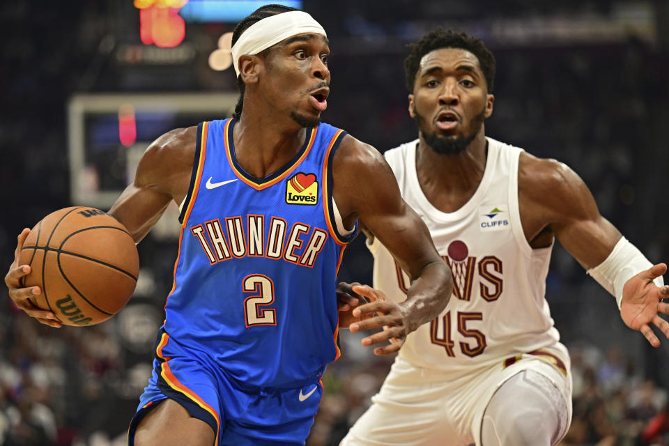 Oklahoma City Thunder guard Shai Gilgeous-Alexander (2) drives against Cleveland Cavaliers guard Donovan Mitchell (45) in the first half of an NBA basketball game, Friday, Oct. 27, 2023, in Cleveland. (AP Photo/David Dermer)