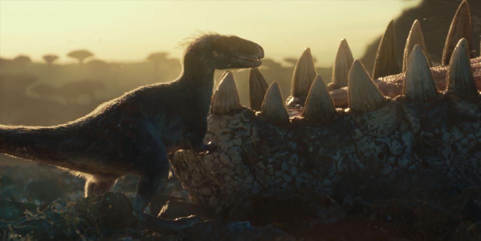 A Moros intrepidus picks food remnants from the teeth of a Giganotosaurus in "Jurassic World Dominion."