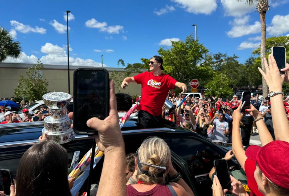 Matthew Tkachuk celebrates outside the Pompano Beach Raisin Cane's on Thursday surrounded by fans and Stanley Cups (none of them were real).